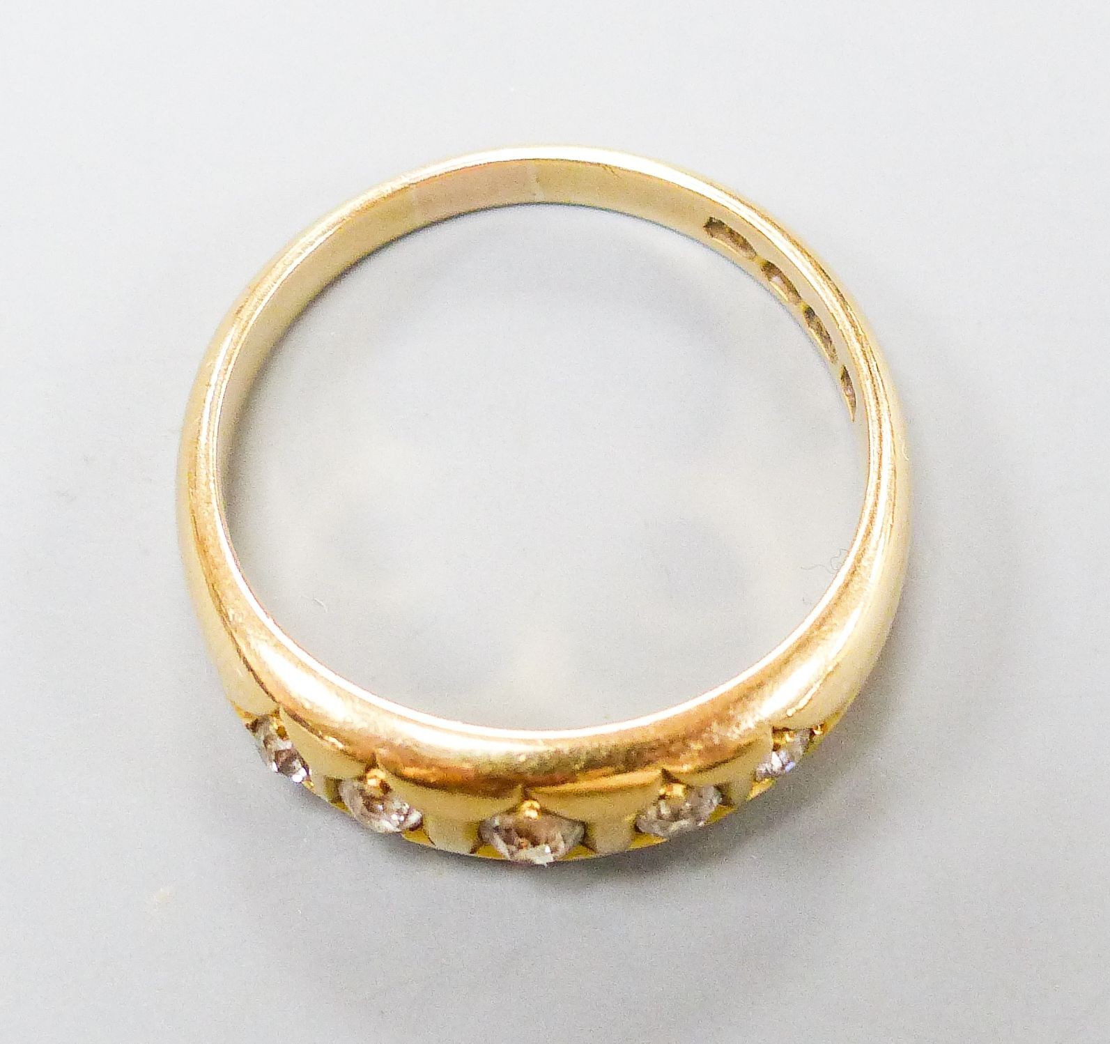 A late Victorian 18ct gold and graduated five stone gypsy set five stone ring, size Q, gross weight 5.5 grams.